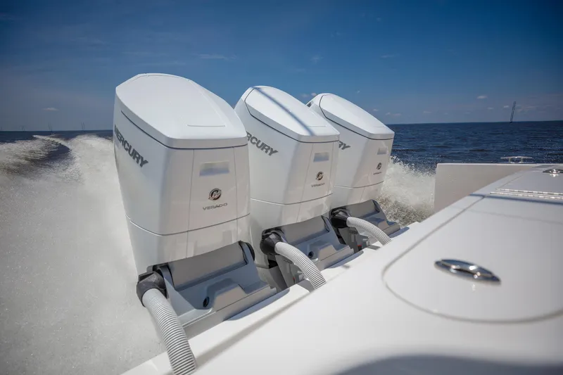 Slide: The Image of Triple Mercury Verado engines powering a 2025 Albemarle 45 Carolinian boat on open water. - 26