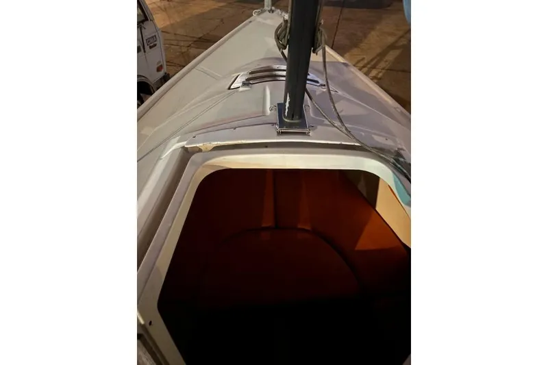 Slide: The Image of 1986 O'Day 19 sailboat cabin entrance with visible mast and deck details. - 12