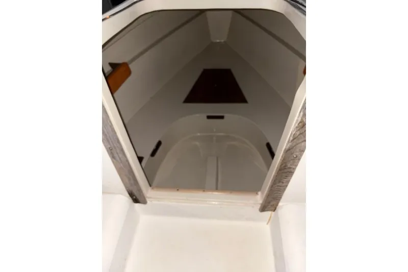 Slide: The Image of 1986 O'Day 19 sailboat interior cabin view, showcasing compact and clean design. - 14