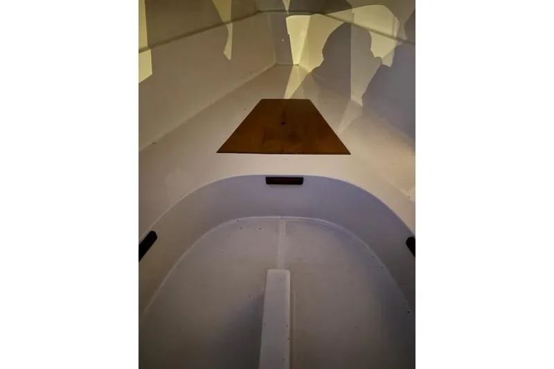 Slide: The Image of Interior view of a 1986 O'Day 19 sailboat, showcasing its clean, minimalist design. - 15