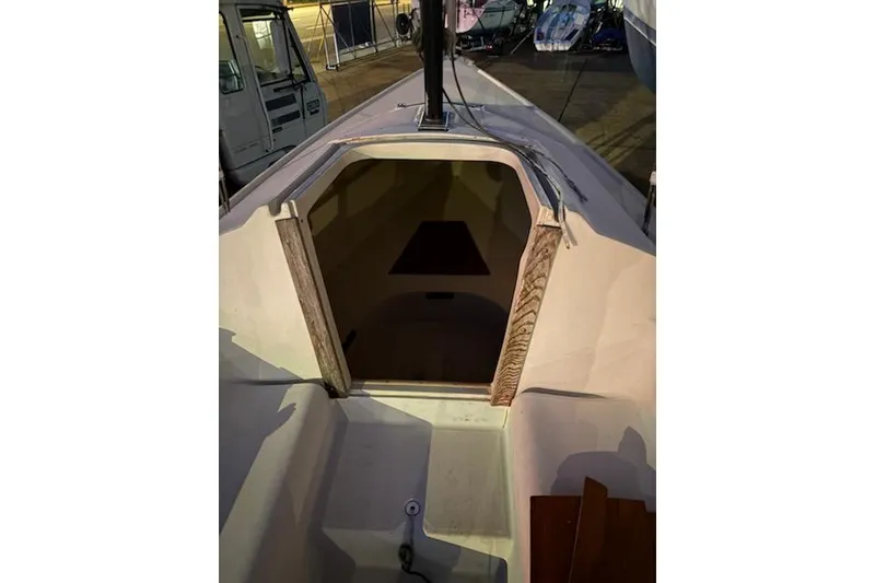 Slide: The Image of 1986 O'Day 19 sailboat cockpit and cabin entrance, docked in a marina. - 17