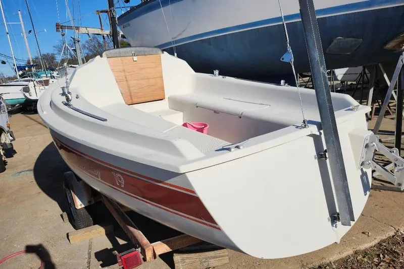 Slide: The Image of 1986 O'Day 19 sailboat on trailer, docked outdoors under clear blue sky. - 21