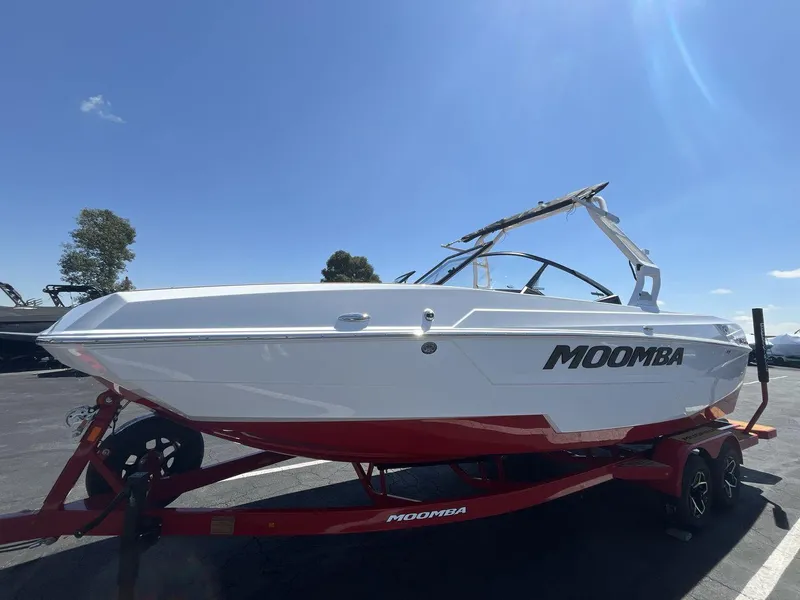 Slide: The Image of 2025 Moomba Tykon boat on trailer under clear blue sky. - 1