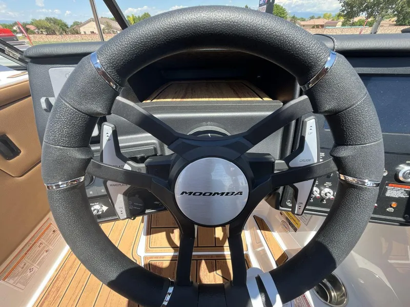 Slide: The Image of Steering wheel of 2025 Moomba Tykon boat, featuring modern controls and sleek design. - 14