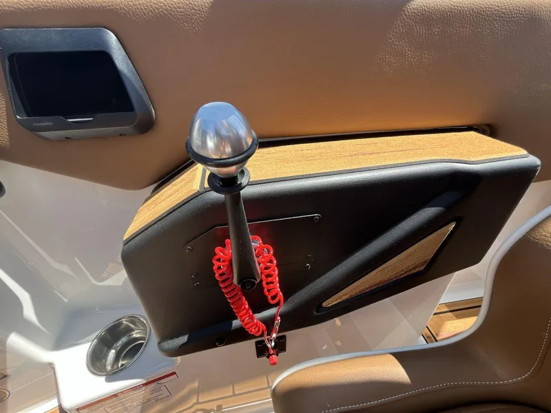 Slide: The Image of Interior of 2025 Moomba Tykon boat with control panel and red safety cord. - 16