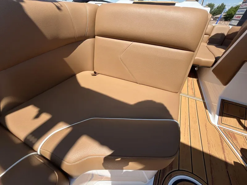 Slide: The Image of 2025 Moomba Tykon boat interior with tan leather seating and wood flooring. - 17