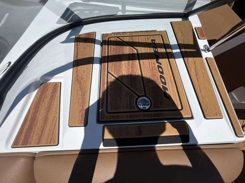 Slide: The Image of 2025 Moomba Tykon boat deck with wood finish and logo in sunlight. - 18