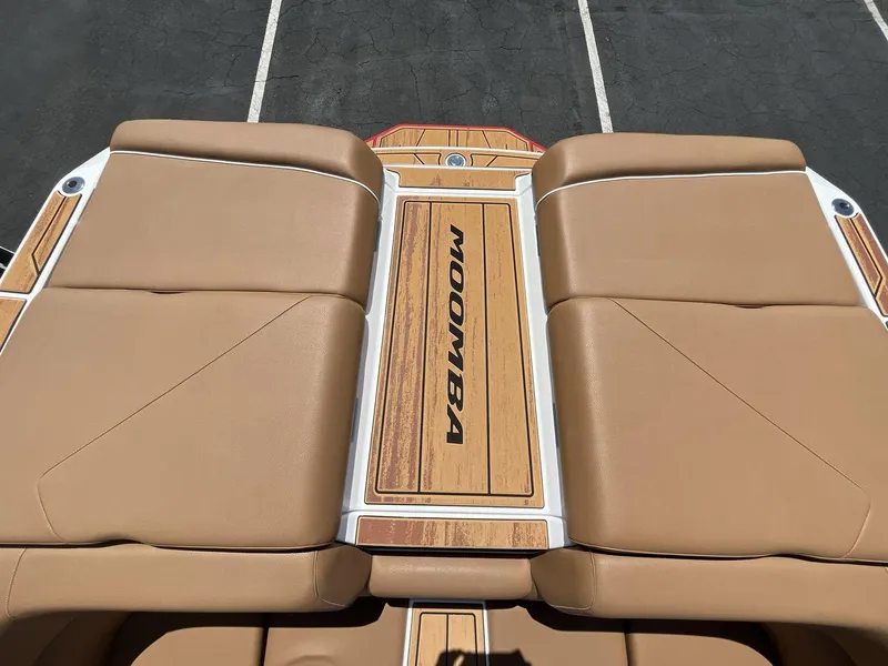 Slide: The Image of 2025 Moomba Tykon boat with tan seating and wood accents, viewed from above. - 19
