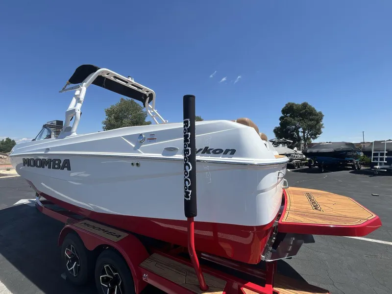 Slide: The Image of 2025 Moomba Tykon boat on trailer, white and red design, clear blue sky background. - 3