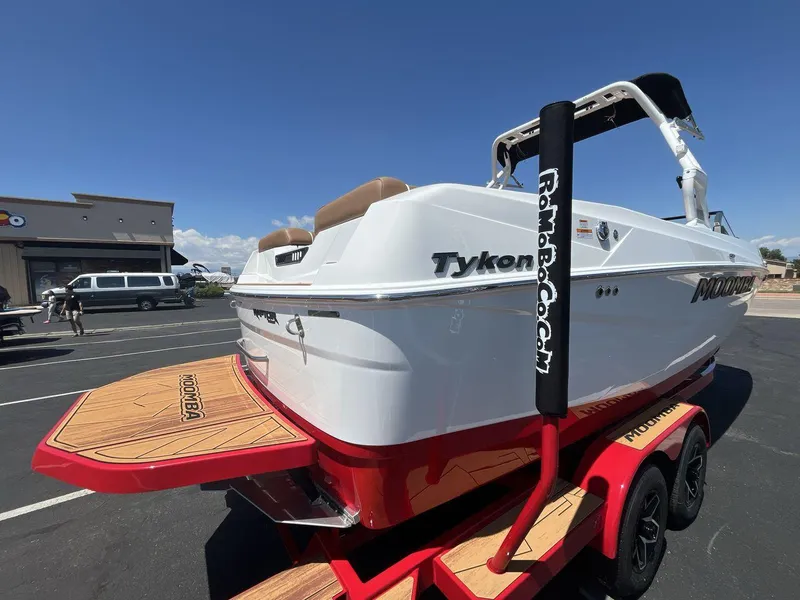 Slide: The Image of 2025 Moomba Tykon boat on trailer, white and red design, parked outdoors. - 5