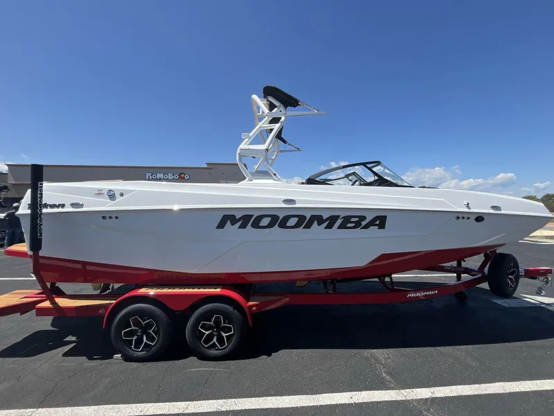 Slide: The Image of 2025 Moomba Tykon boat on a red trailer under a clear blue sky. - 6