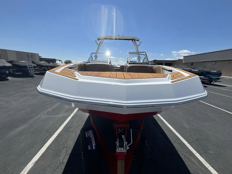 Slide: The Image of 2025 Moomba Tykon boat with sleek design, parked outdoors under clear blue sky. - 8