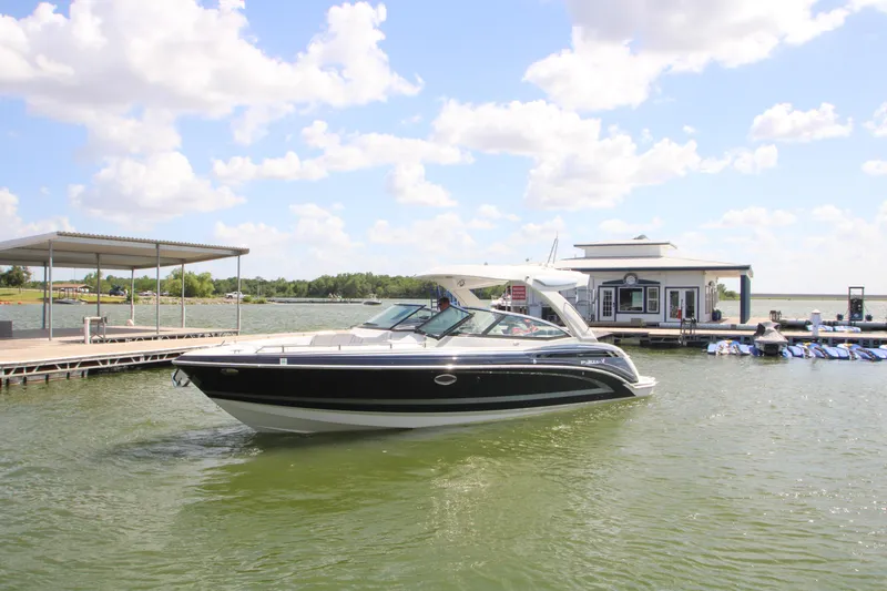 The Image of 2020 Formula 330 Crossover Bowrider docked at a marina under a sunny sky. - 0