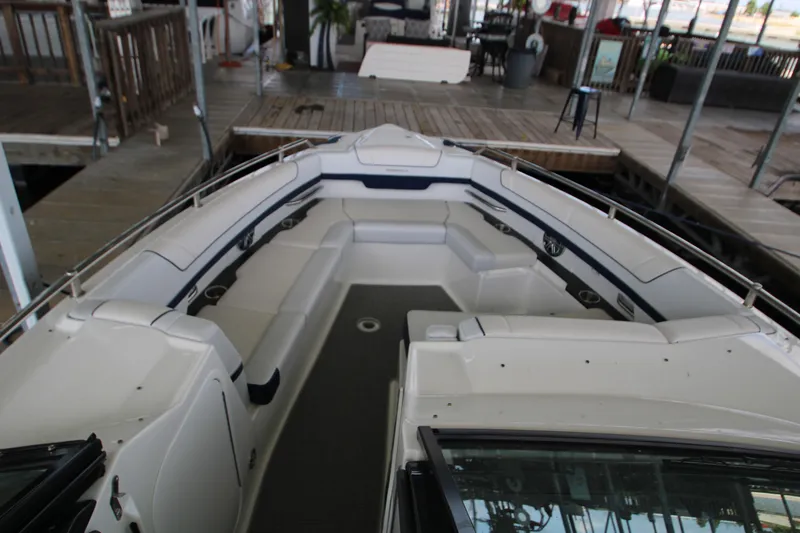 Slide: The Image of 2020 Formula 330 Crossover Bowrider interior with white seating and stainless steel accents. - 12