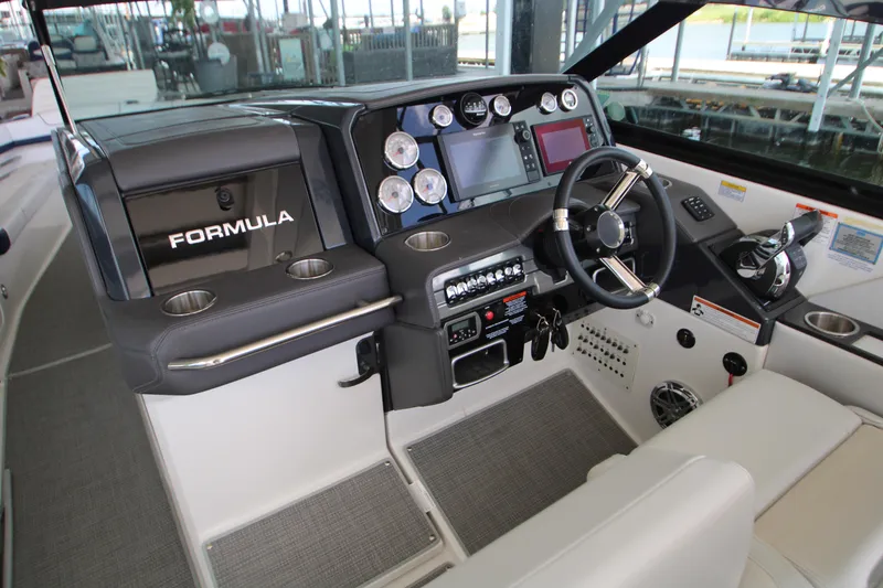 Slide: The Image of 2020 Formula 330 Crossover Bowrider cockpit with modern controls and steering wheel. - 13