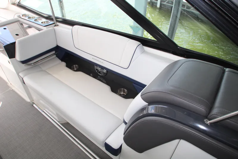 Slide: The Image of 2020 Formula 330 Crossover Bowrider interior seating with cup holders and sleek design. - 14