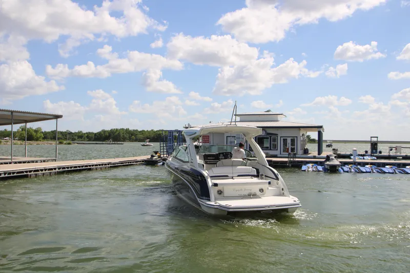 Slide: The Image of 2020 Formula 330 Crossover Bowrider with spacious seating at a dock. - 2