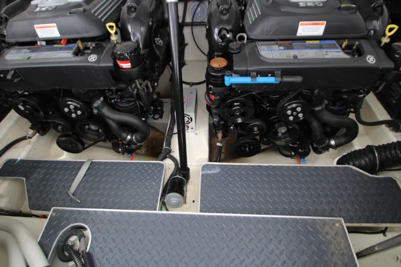 Slide: The Image of Engine compartment of a 2020 Formula 330 Crossover Bowrider, featuring dual engines and mechanical components. - 26