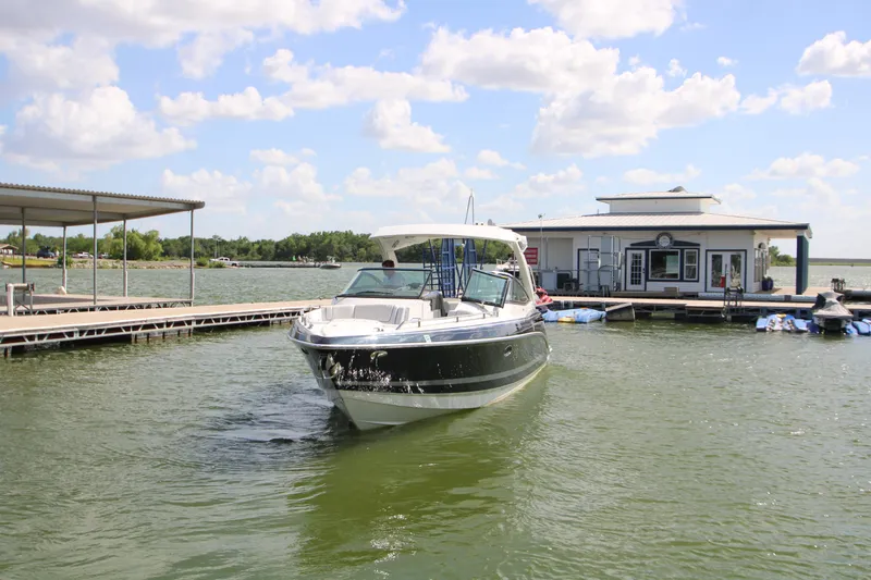 Slide: The Image of 2020 Formula 330 Crossover Bowrider at a marina on a sunny day. - 36