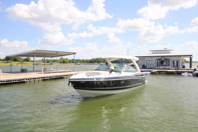 Slide: The Image of 2020 Formula 330 Crossover Bowrider docked on a sunny lake with blue skies. - 38
