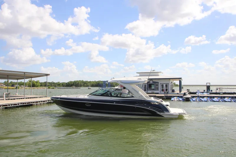 Slide: The Image of 2020 Formula 330 Crossover Bowrider on a sunny lake near a dock. - 43