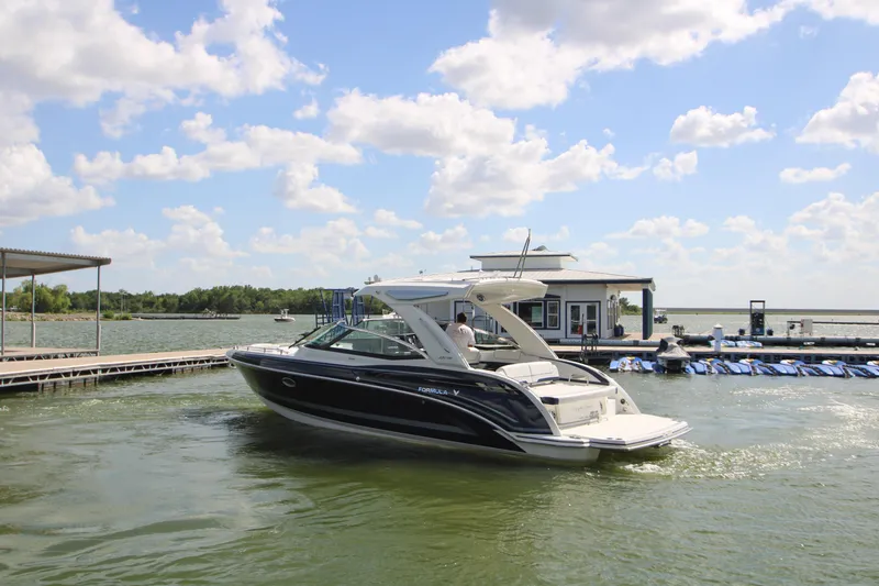 Slide: The Image of 2020 Formula 330 Crossover Bowrider docked on a sunny day with blue skies. - 45