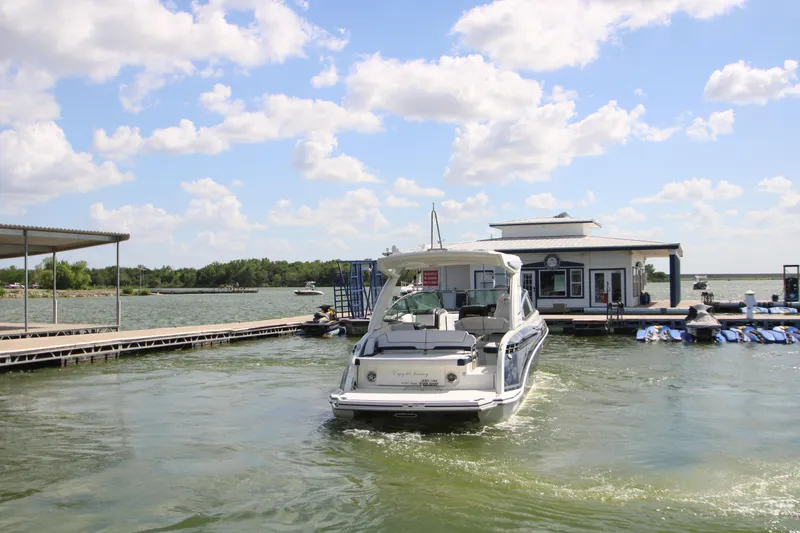 Slide: The Image of 2020 Formula 330 Crossover Bowrider at a marina on a sunny day. - 48