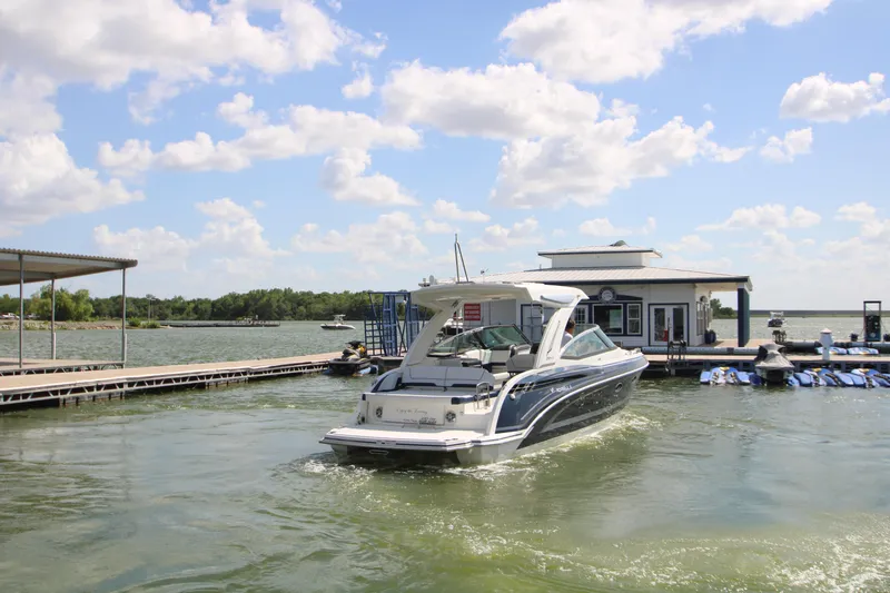 Slide: The Image of 2020 Formula 330 Crossover Bowrider at a marina on a sunny day. - 49