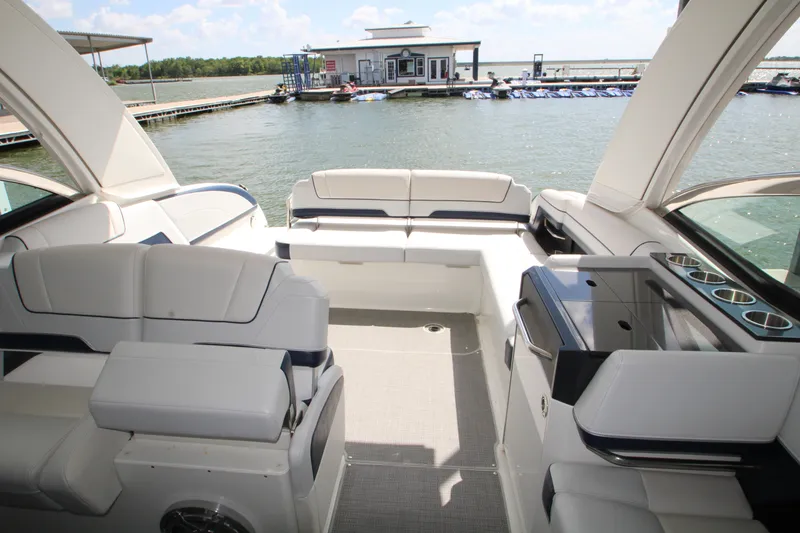 Slide: The Image of 2020 Formula 330 Crossover Bowrider at a marina, under a partly cloudy sky. - 5