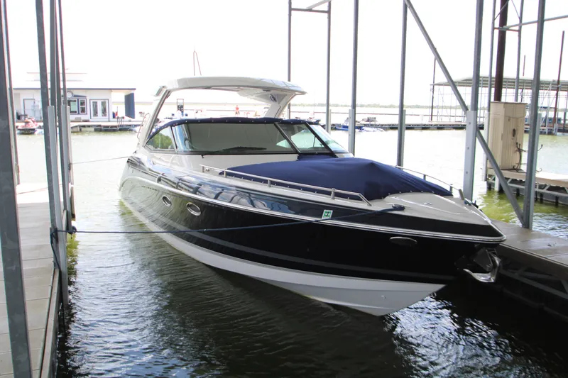 Slide: The Image of 2020 Formula 330 Crossover Bowrider docked in a marina, featuring sleek design and blue cover. - 53