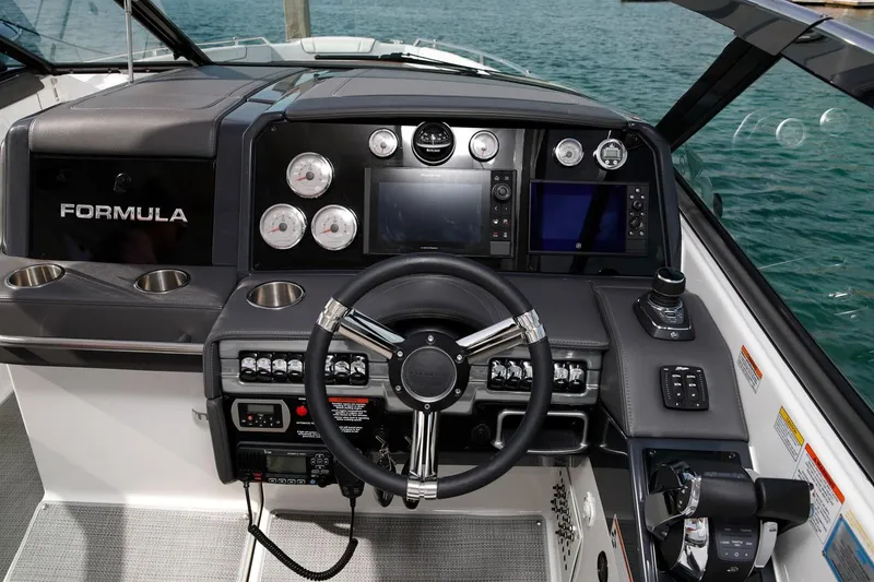 Slide: The Image of Manufacturer Provided Image: 2020 Formula 330 Crossover Bowrider dashboard with steering wheel and navigation controls. - 65