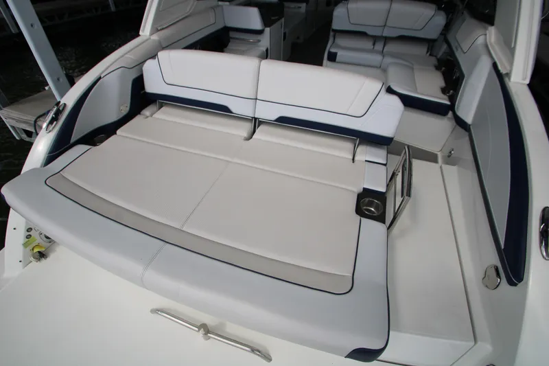 Slide: The Image of 2020 Formula 330 Crossover Bowrider interior with helm, seating, and lake view. - 7