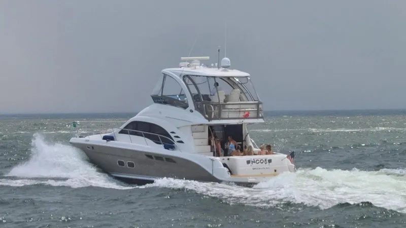 Slide: The Image of 2006 Sea Ray 52 Sedan Bridge yacht cruising on open water. - 12