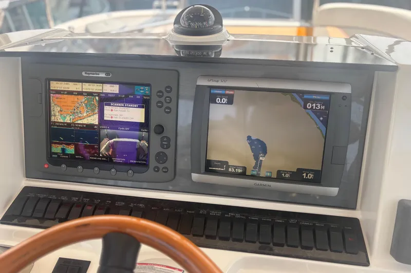 Slide: The Image of Control panel of a 2006 Sea Ray 52 Sedan Bridge with navigation screens. - 21