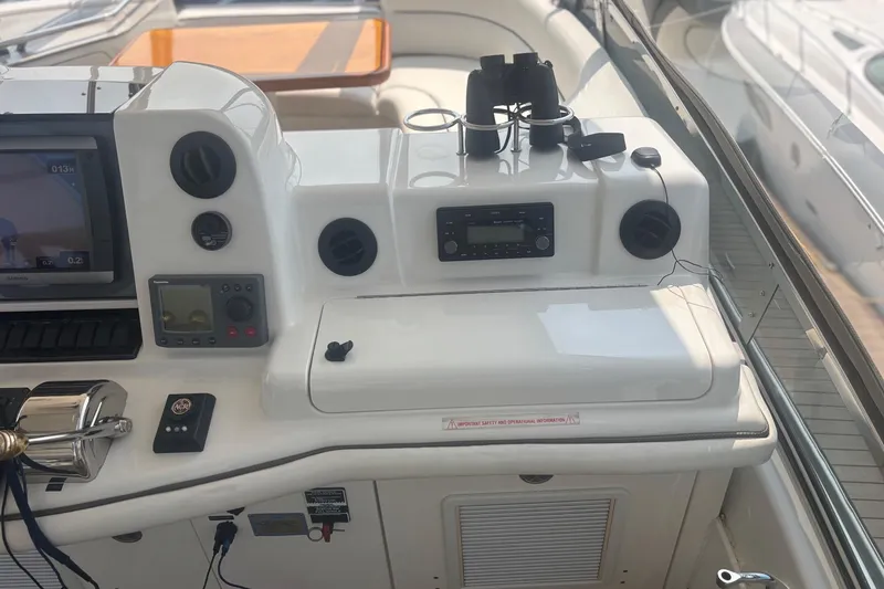 Slide: The Image of 2006 Sea Ray 52 Sedan Bridge helm with navigation equipment and controls. - 22