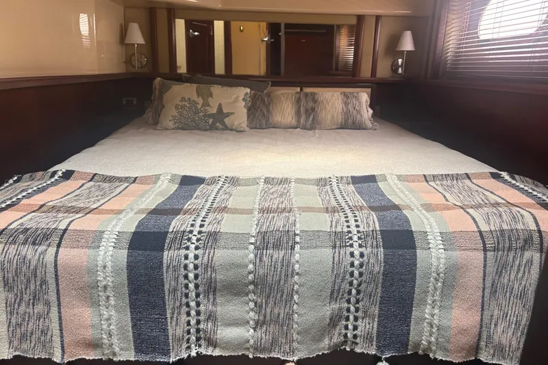 Slide: The Image of Luxurious bedroom interior of 2006 Sea Ray 52 Sedan Bridge yacht with cozy bedding. - 43