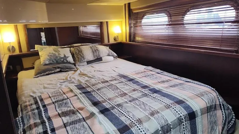 Slide: The Image of Cozy bedroom interior of 2006 Sea Ray 52 Sedan Bridge yacht with decorative pillows. - 44