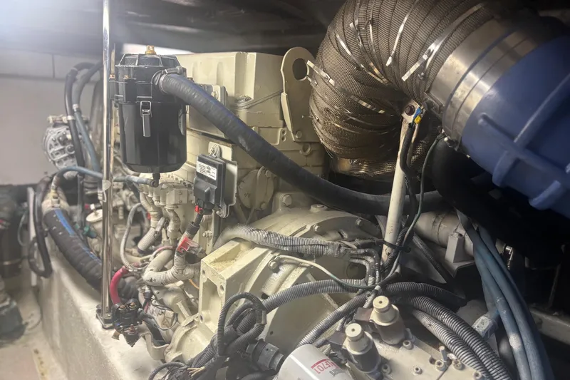 Slide: The Image of Engine room of a 2006 Sea Ray 52 Sedan Bridge yacht, showcasing mechanical components. - 49