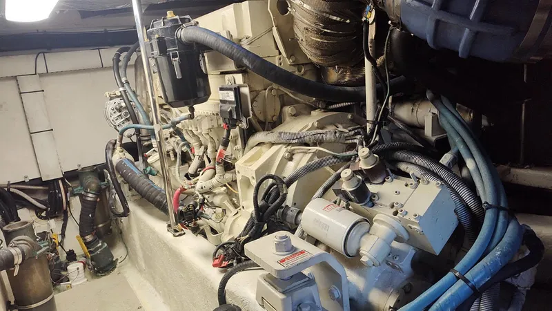 Slide: The Image of Engine compartment of a 2006 Sea Ray 52 Sedan Bridge with visible hoses and components. - 51