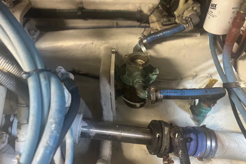 Slide: The Image of Engine compartment of a 2006 Sea Ray 52 Sedan Bridge, showing mechanical components and hoses. - 52