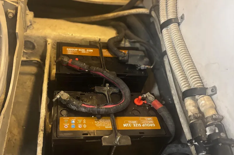 Slide: The Image of Engine room of 2006 Sea Ray 52 Sedan Bridge with visible plumbing and valves. - 56