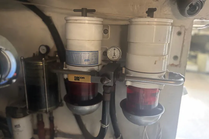 Slide: The Image of Engine room of 2006 Sea Ray 52 Sedan Bridge with fire extinguisher and filters. - 58