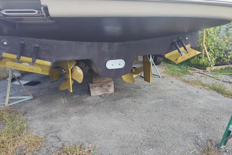 Slide: The Image of 2006 Sea Ray 52 Sedan Bridge boat hull with propellers and rudders on dry dock. - 63