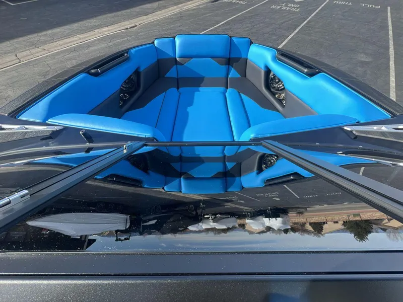 Slide: The Image of 2025 Moomba Mojo boat interior with blue and black seating, viewed from above. - 11