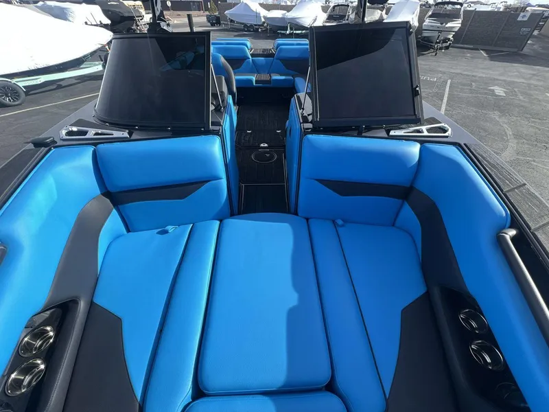 Slide: The Image of 2025 Moomba Mojo boat interior with vibrant blue seating and sleek design. - 12