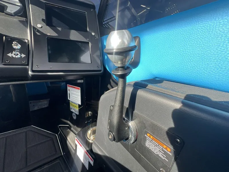Slide: The Image of 2025 Moomba Mojo boat dashboard with control lever and touchscreen display. - 16
