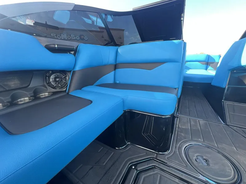Slide: The Image of 2025 Moomba Mojo boat interior with blue seating and speaker system. - 17