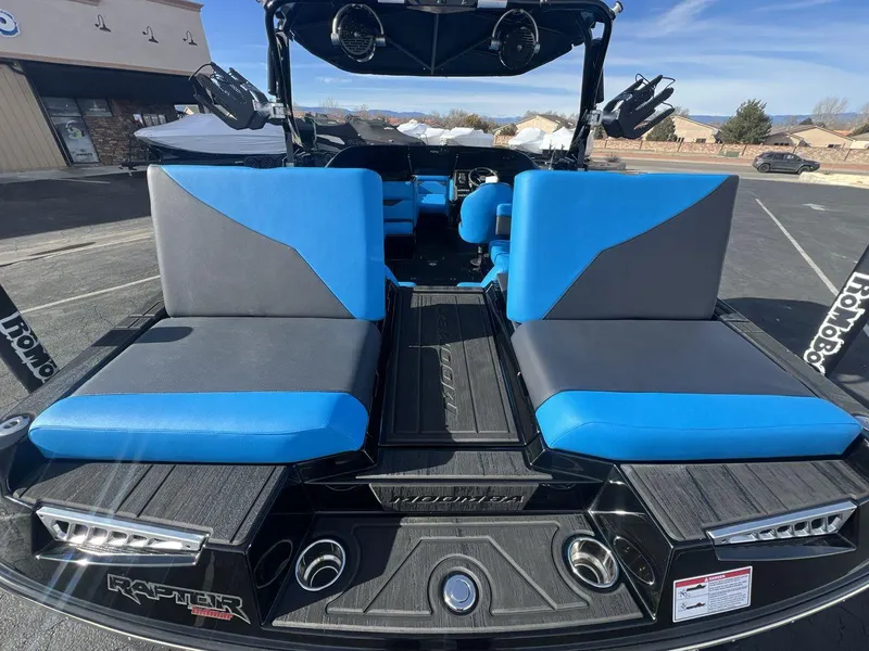 Slide: The Image of 2025 Moomba Mojo boat interior with blue and gray seating, showcasing modern design and comfort. - 24