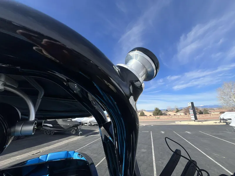 Slide: The Image of 2025 Moomba Mojo boat detail under clear blue sky. - 25