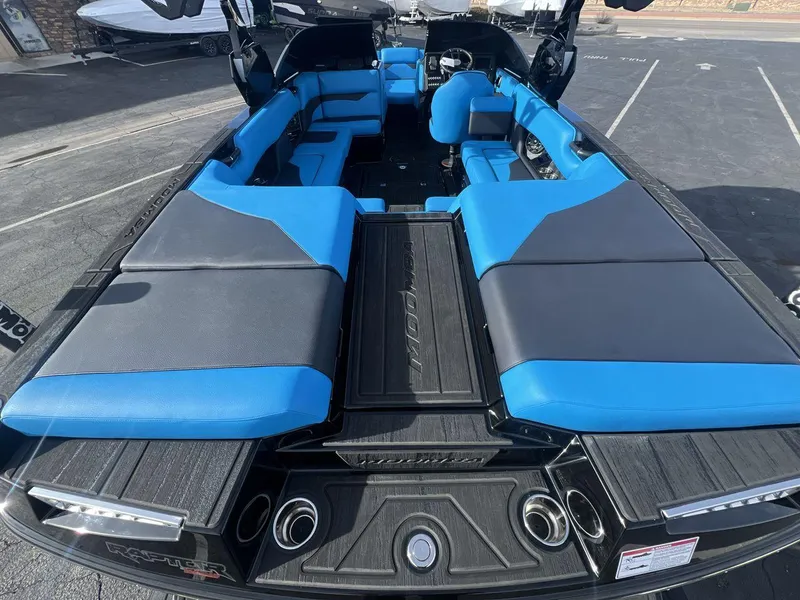 Slide: The Image of 2025 Moomba Mojo boat interior with blue and gray seating, showcasing spacious and modern design. - 27